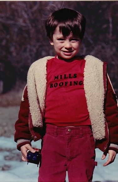 Child with Mills Roofing shirt