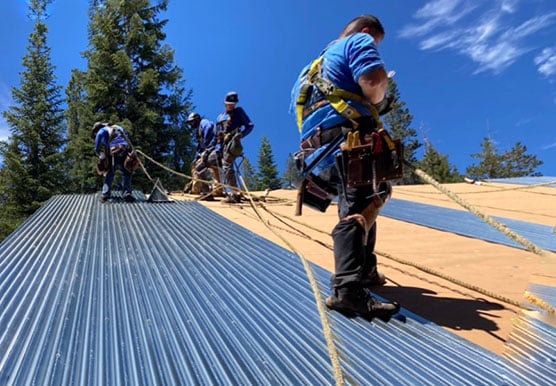 Mills Roofing team installing metal roof