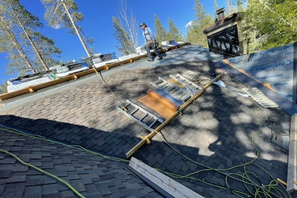 Mills Roofing crew installing new asphalt shingles over CertainTeed underlayment on a Sierra Nevada home
