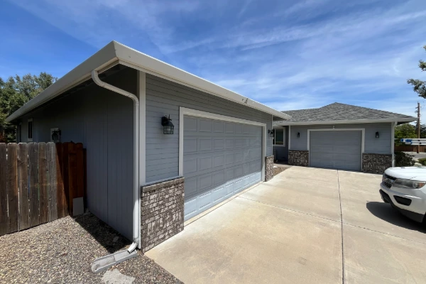 Clear driveway view of an asphalt shingle roof installation on a residential home in Reno, Nevada