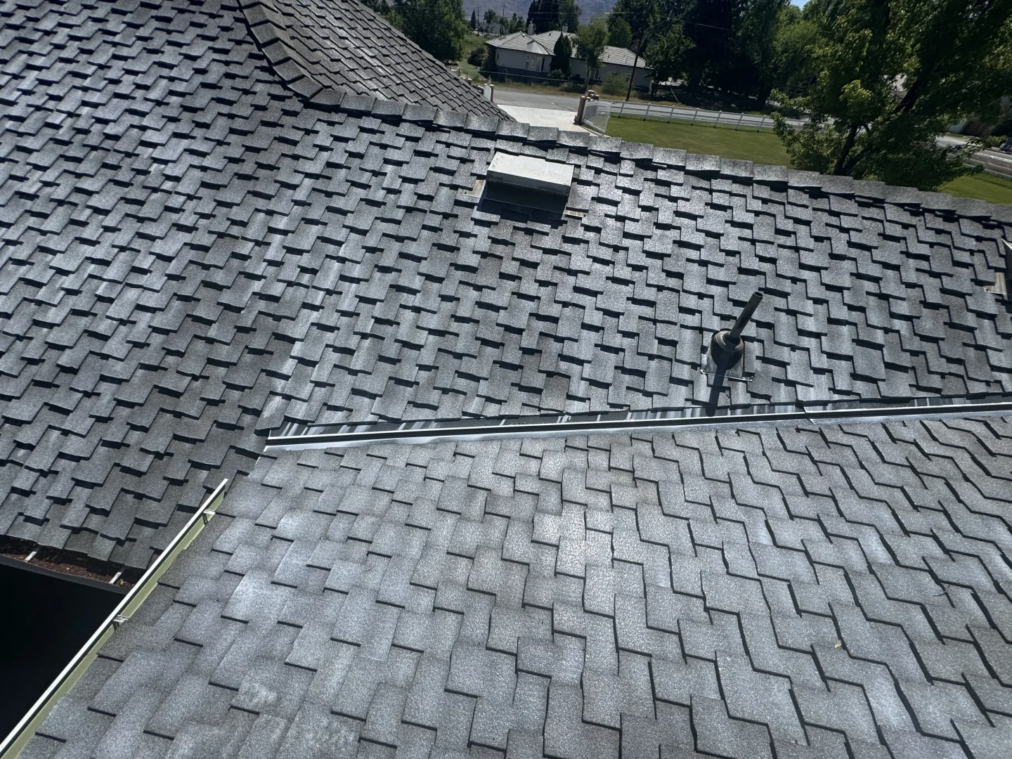 Aerial view of a residential asphalt shingle roof in Northwest Nevada showing shingles in good condition that may qualify for Roof Maxx roof rejuvenation treatment.